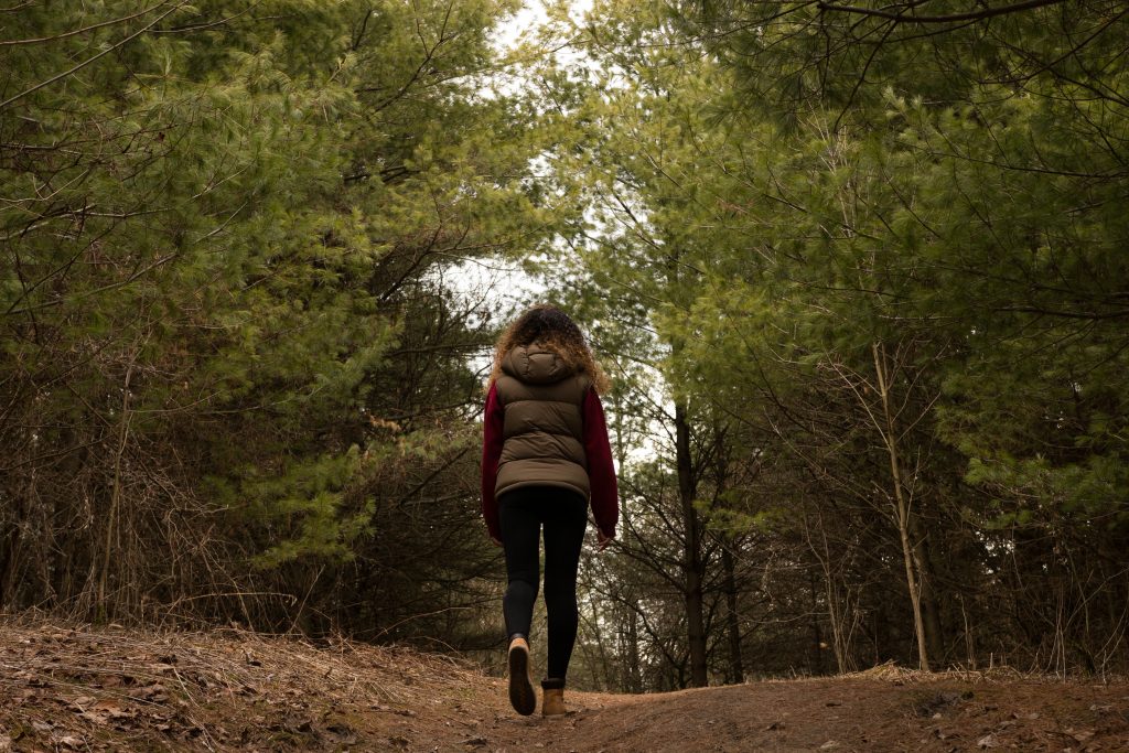 woman-hikes-through-forest-clearing
