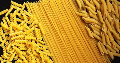 various-types-of-uncooked-pasta-on-black-counter